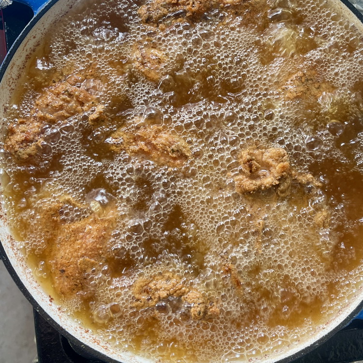 Image of Continue frying, turning each piece as needed, until the chicken is golden brown and cooked through (165°F internal temperature).